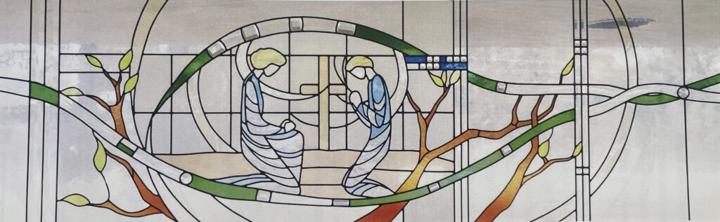 stained glass window of two saints kneeling. 