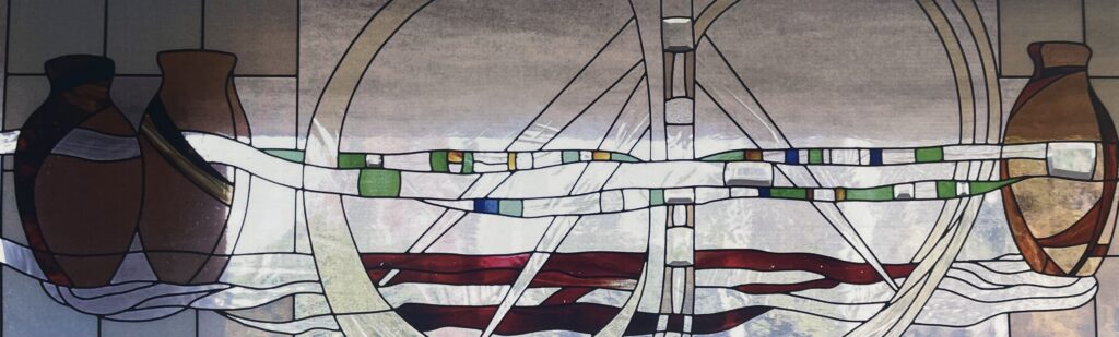 stained glass window of vases with wine. 