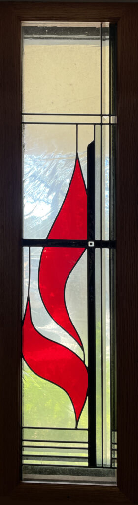 stained glass window of Methodist church symbol. 