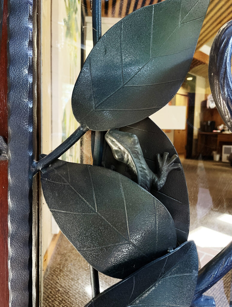 close up of metal lizard hiding in the leaves. 