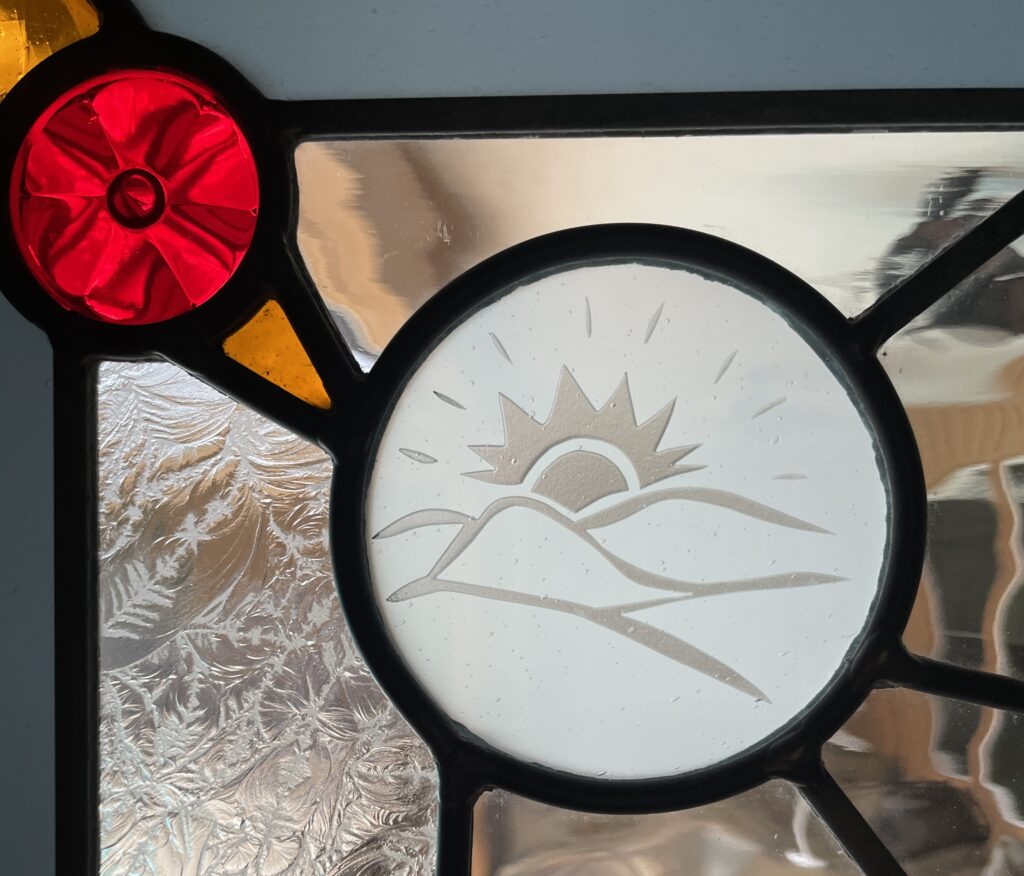 up close detail of etched glass sun. 