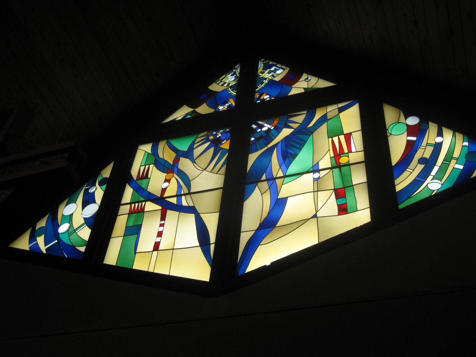 abstract stained glass window with blue, amber, and green colors. 